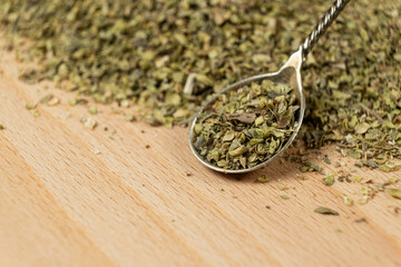 Natural Italian Spice Dried Chopped Oregano in a Spoon, Place for Text