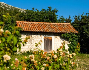 Rustic stone cottage amidst vibrant foliage, a tranquil countryside setting