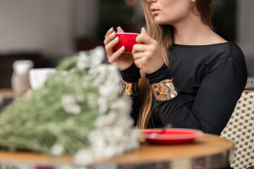 Woman Coffee Flowers Relaxing at Cafe on sunny day for a break.