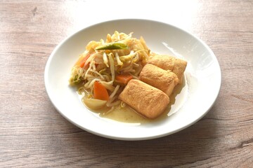 fried bean sprout with slice pickled cabbage and egg tofu in plate on table