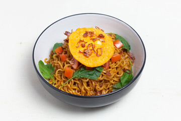 Classic Indonesian instant noodles, Indomie Goreng, with a fried egg. This close-up highlights the rich seasonings and perfectly cooked noodles.
