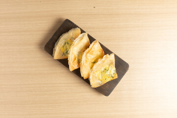 Martabak telur is an Indonesian street food favorite: a crispy, pan-fried pastry filled with a savory mix of beef, egg, and spring onion.