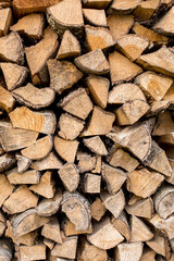 Background image of a stack of firewood. The concept of preparing firewood for the winter.