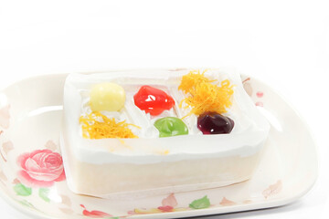 Gourmet dessert closeup with a fresh fruit cake topped with sweet strawberries and raspberries