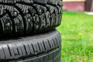 Car tire shop concept , New car tire and tire stacked on sideways background with copy space for...