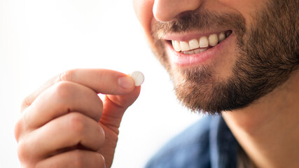 Treatment, medicine, medication, pills, vitamins, supplements concept. Unrecognizable bearded...