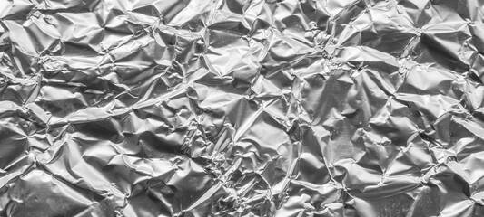 Shiny metal silver gray foil leaf crumpled texture background