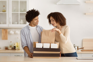 Delivery of delicious food home, positive emotions during covid-19. Young african american woman...
