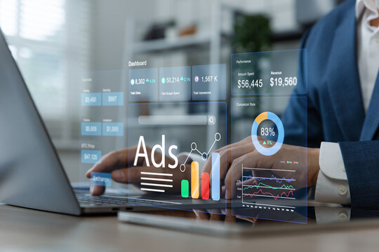Businessman using laptop to monitor online advertising metrics through a digital dashboard.