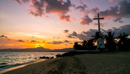Sunset over the beach with a cross