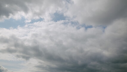 A dynamic and beautiful cloudy sky adorned with subtle patches of deep and calming blue hues