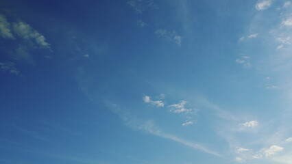 The sky is a beautiful clear blue filled with wispy, delicate clouds scattered throughout