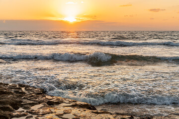  landscape of rocky seashore on a windy evening sunset golden hour