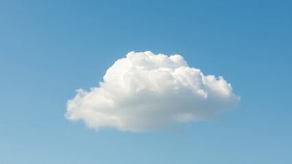 Fluffy cumulus cloud isolated against clear blue sky with soft aerial perspective and natural daylight.