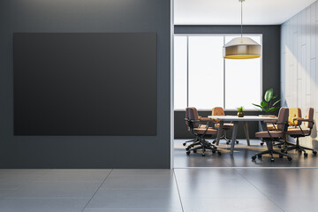 Fototapeta premium Empty black poster mockup on dark wall near modern office meeting room with large window and chairs in corporate interior design setting. 3D Rendering