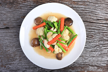 Stir fried mixed vegetables for vegetarian, Healthy stir fried vegetables in the white plate close up