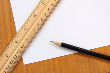 white blank note paper with pencil and ruler background.