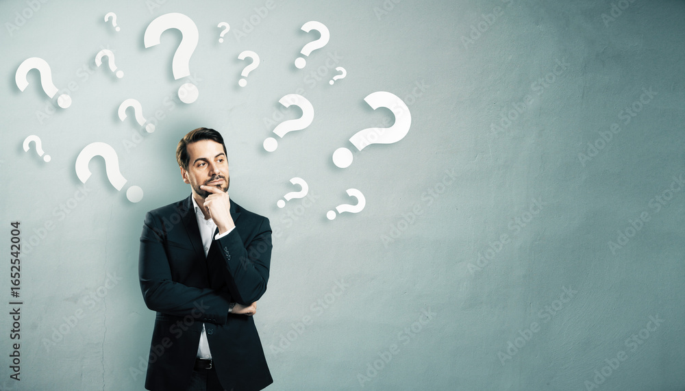Poster thoughtful businessman standing in front of a wall with floating question marks, symbolizing decisio