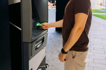 Man using ATM outdoors