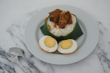 Nasi Lemak with Egg and Fried Crispy Rendang Beef on a Plate