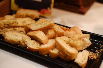 Close-up of garlic bread slices on a serving tray
