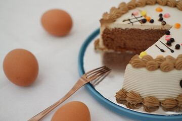 Chocolate cake with decorative frosting and eggs on a plate