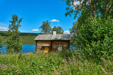 typical swedish log hut or cabin in the woods.
