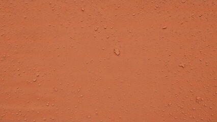 Fototapeta premium Rough textured wall with peeling brown and orange paint on outdoor surface