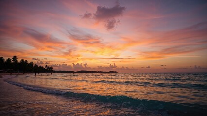 Evening beach scene with dark figures and colorful sky