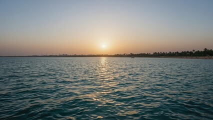 Obraz premium Morning light over coastal waters with a sandy shore