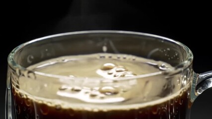 Steaming Cup of Coffee on a Black Background A Close-Up Shot