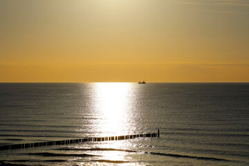 At dusk, the sun lights up the surface of the Baltic Sea, as seen from Mielno in Poland