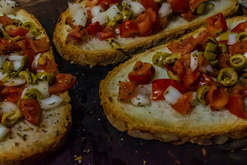 Fresh Bruschetta Toast with Tomatoes, Onions, and Olives on Rustic Bread