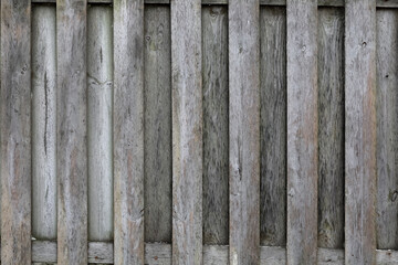 Rough, weathered planks are part of a wooden fence