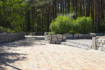 The green space is traversed by park alleys in Mielno, Poland