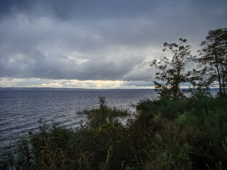 In the evening on a large river in rainy weather.