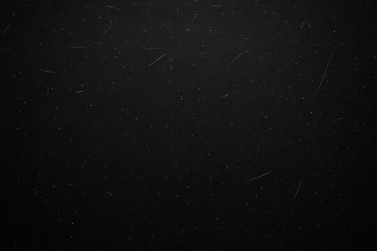 Close-up of a TV display showing dust and scratches on a dark, textured background with empty area for content
