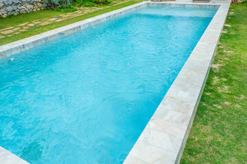 Empty swimming pool with sunbed and white umbrella in resort hotel for vacation leisure and white...