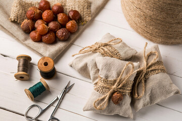 Handmade eco-friendly linen sachets with twine, soap nuts, and sewing accessories.