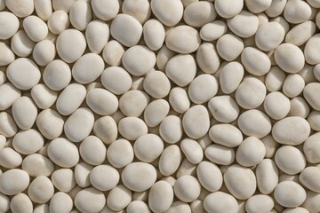 Sea pebbles scattered on a patterned ground background