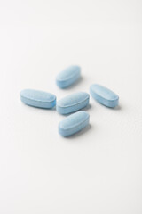 Multivitamin tablets on bright paper background. Close up. Copy space	