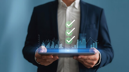 Businessman holding a tablet displaying a digital interface with glowing checkmarks and a cityscape