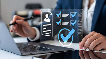 Person reviewing a digital checklist and resume on a transparent screen with a laptop and pen