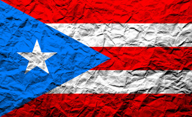 Crumpled flag of Puerto Rico displaying vibrant colors and symbols