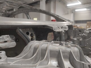 New car body. Gray metal texture. Close-up. Car production. Automotive industry. Car assembly....