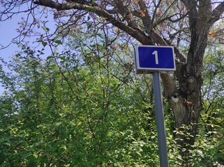 Road sign 1. First kilometer. Start of the countdown. Start of the journey. First mile. 1 mile. 1 km