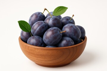 Freshly picked plums arranged in a wooden dish on a plain white background