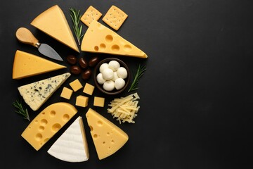 Assorted cheese and snack platter arranged on a black stone backdrop, top view with room for writing