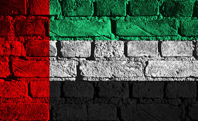 Vibrant mural capturing the essence of the UAE flag on textured brick