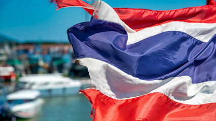 Close-up of the Thai flag with red, white, and blue stripes symbolizing the nation
